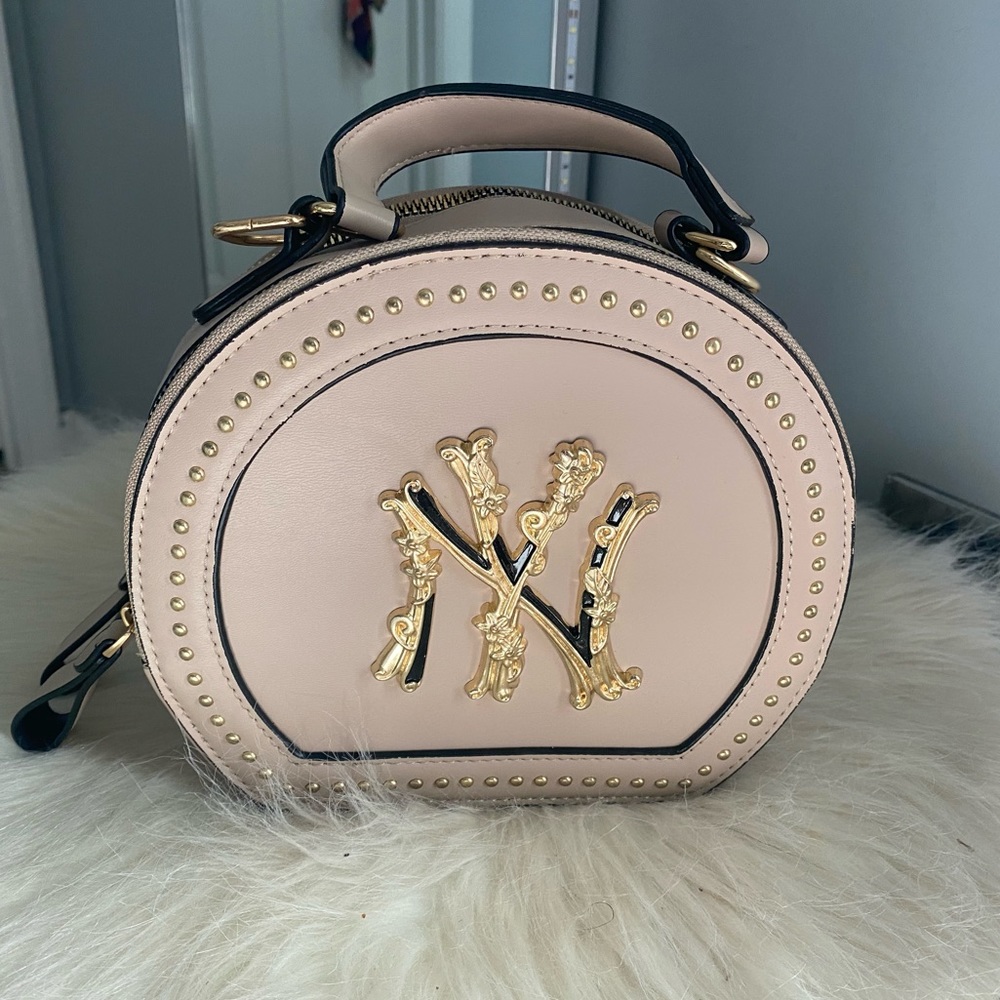 Nude crossbody bag with gold NY Yankees symbol